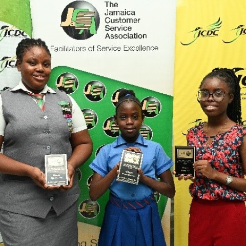 Honessa Clayton, Kamea Campbell, and Jamelia Grant proudly display their trophies as winners of the 2024 Jamaica Customer Service Competition Through Poetry, presented by the Jamaica Cultural Development Commission (JCDC) in partnership with the Jamaica Customer Service Association (JaCSA).